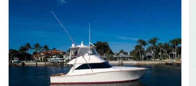 Farmers Daughter Yacht Photos Pics 2004 Viking 45 Convertible yacht on calm water with palm trees in the background.