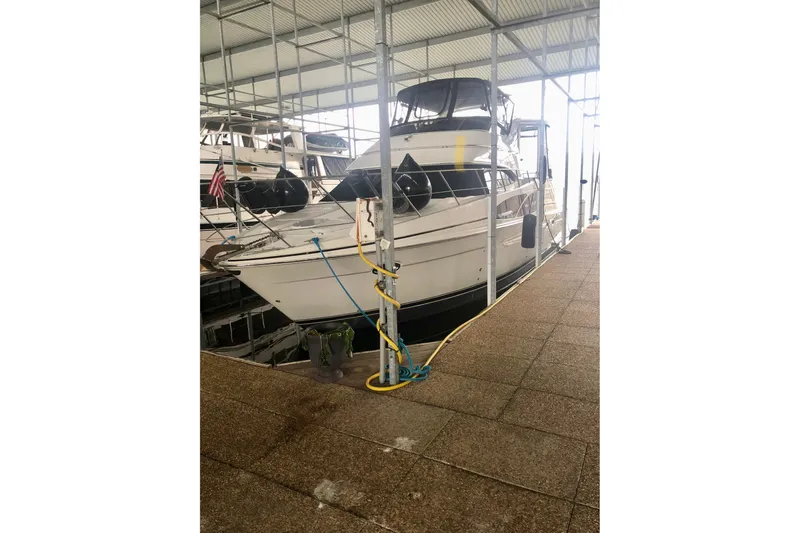 Fire Away Yacht Photos Pics 2005 Carver 444 Cockpit Motor Yacht docked in a covered marina.