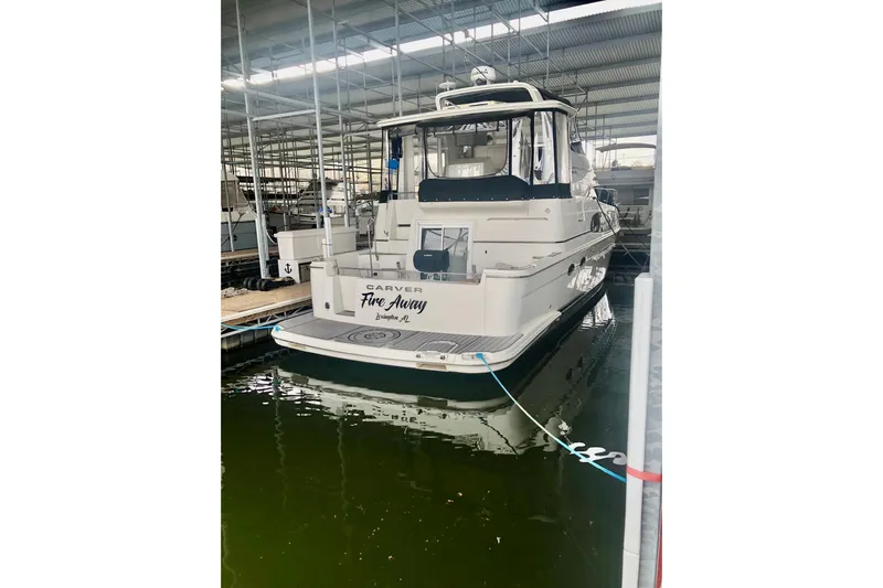 Fire Away Yacht Photos Pics 2005 Carver 444 Cockpit Motor Yacht docked in a marina.