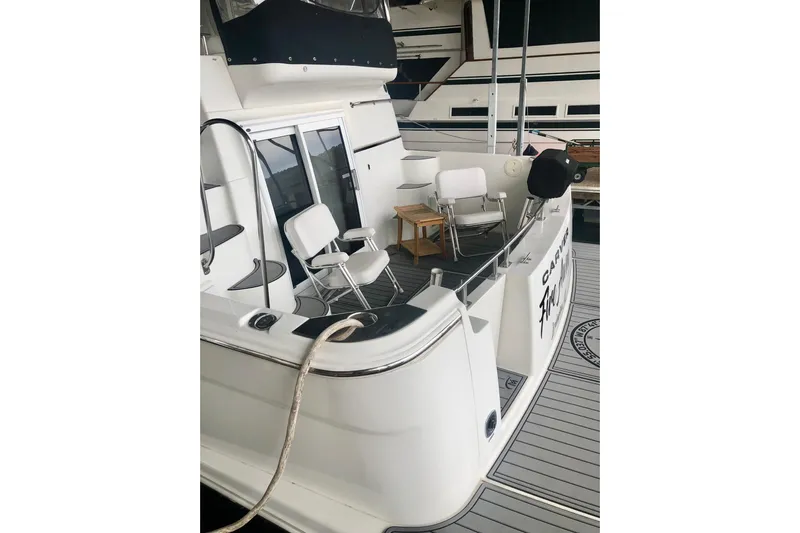 Fire Away Yacht Photos Pics 2005 Carver 444 Cockpit Motor Yacht with seating area and deck view.