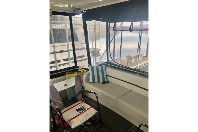 Fire Away Yacht Photos Pics 2005 Carver 444 Cockpit Motor Yacht interior with seating and lake view.