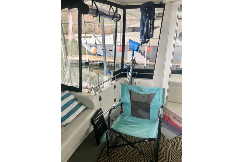 Fire Away Yacht Photos Pics 2005 Carver 444 Cockpit Motor Yacht interior with chair and nautical accessories.