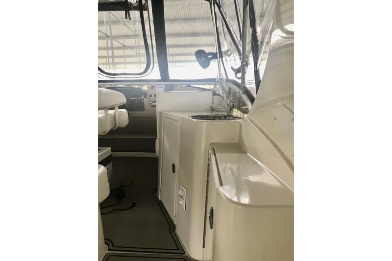 Fire Away Yacht Photos Pics 2005 Carver 444 Cockpit Motor Yacht interior with seating and control panel.