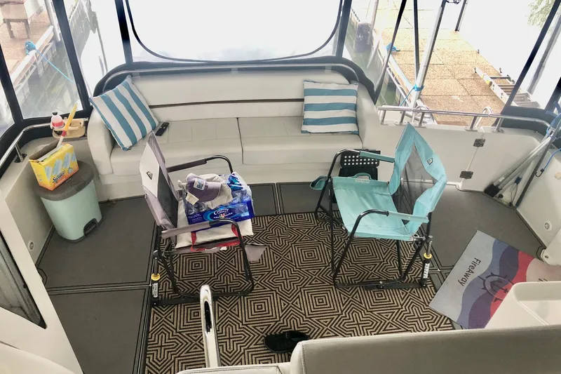 Fire Away Yacht Photos Pics 2005 Carver 444 Cockpit Motor Yacht interior with seating and striped cushions.