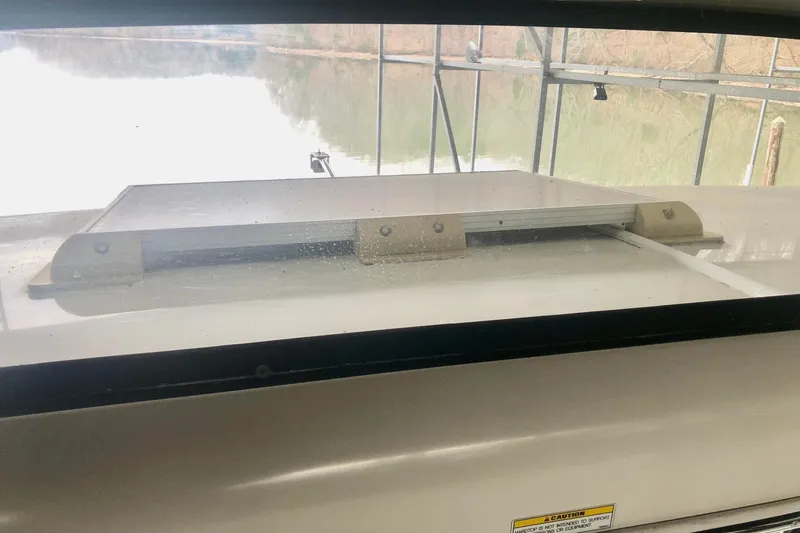 Fire Away Yacht Photos Pics 2005 Carver 444 Cockpit Motor Yacht window view with water and dock background.