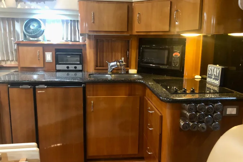 Fire Away Yacht Photos Pics Luxurious kitchen in 2005 Carver 444 Cockpit Motor Yacht with modern appliances.