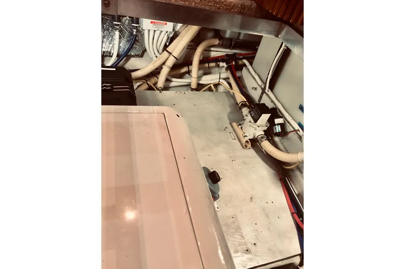 Fire Away Yacht Photos Pics Engine room of 2005 Carver 444 Cockpit Motor Yacht with visible piping and equipment.