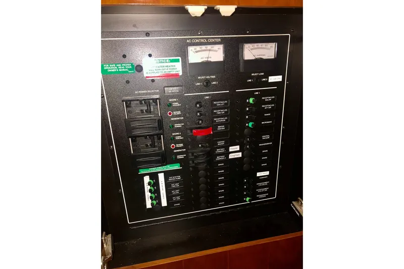 Fire Away Yacht Photos Pics Electrical control panel of 2005 Carver 444 Cockpit Motor Yacht, featuring switches and meters.