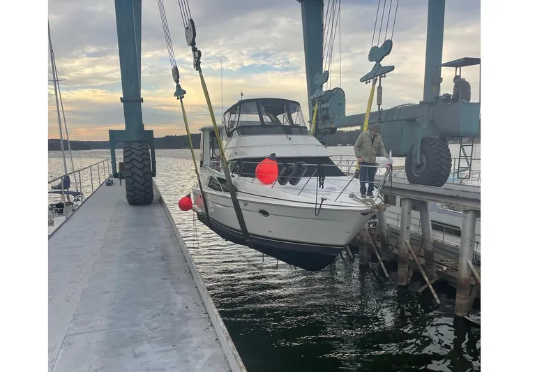 Fire Away Yacht Photos Pics Carver 444 Cockpit Motor Yacht 2005 being lowered into water by crane.