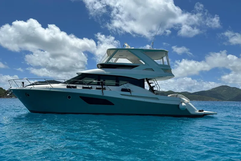  Yacht Photos Pics 2020 Tiara Yachts F53 Flybridge on clear blue water under a bright sky.