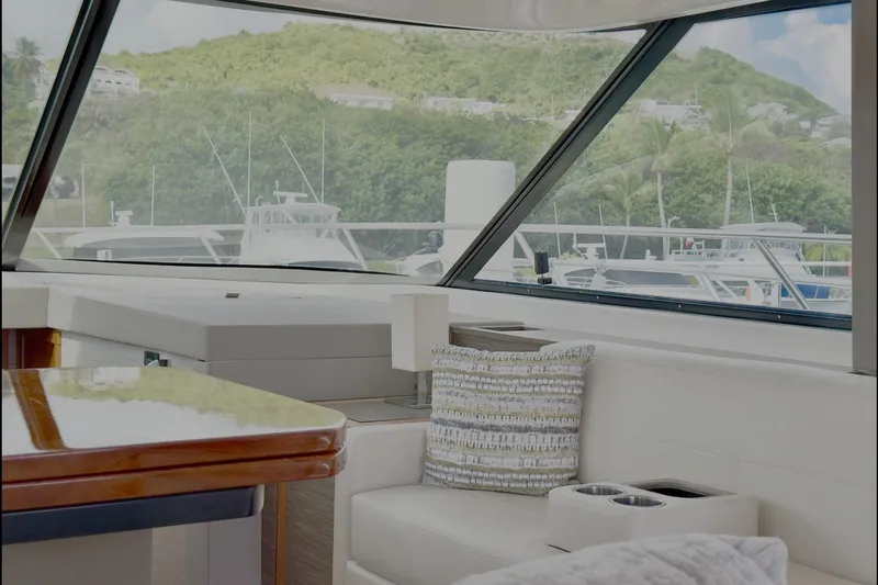  Yacht Photos Pics Interior view of 2020 Tiara Yachts F53 Flybridge, featuring elegant seating and scenic marina backdrop.