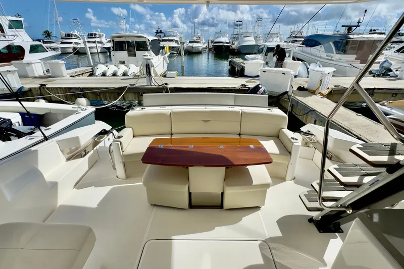  Yacht Photos Pics 2020 Tiara Yachts F53 Flybridge at marina, featuring elegant seating and wooden table.