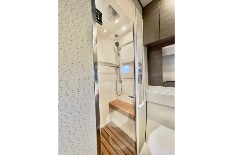  Yacht Photos Pics Luxurious shower in 2020 Tiara Yachts F53 Flybridge, featuring modern fixtures and wooden accents.