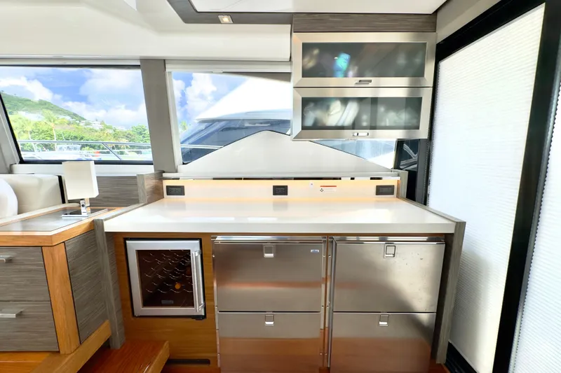  Yacht Photos Pics Modern kitchen area in a 2020 Tiara Yachts F53 Flybridge, featuring sleek cabinetry and appliances.