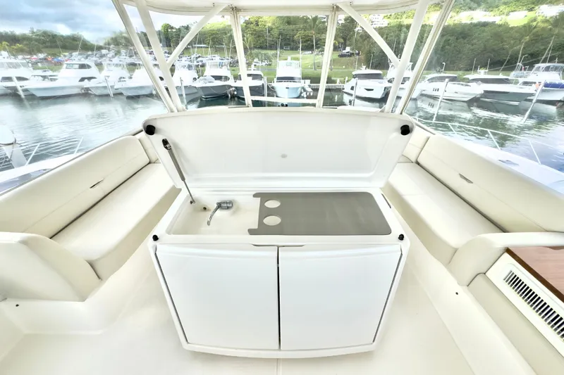  Yacht Photos Pics 2020 Tiara Yachts F53 Flybridge interior with seating and kitchenette, docked at marina.