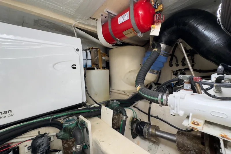  Yacht Photos Pics Engine room of 2020 Tiara Yachts F53 Flybridge with Cummins generator and fire extinguisher.