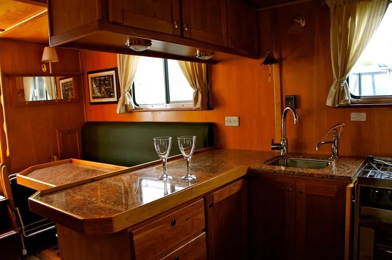  Yacht Photos Pics Interior of a 2010 Custom Trawler with wooden cabinetry and granite countertops.