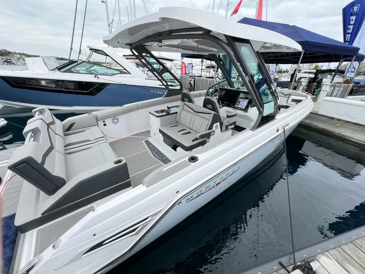  Yacht Photos Pics 2025 Monterey Elite 30 OB boat docked, featuring sleek design and spacious seating.