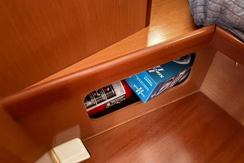  Yacht Photos Pics Storage compartment in 2008 Beneteau 49 yacht with fire extinguisher and box.