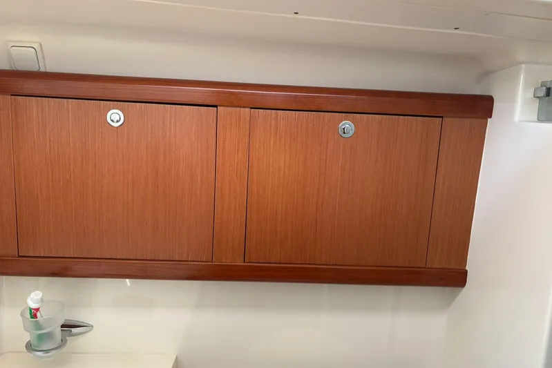  Yacht Photos Pics Wooden cabinet in 2008 Beneteau 49 yacht interior, with toothbrush holder below.