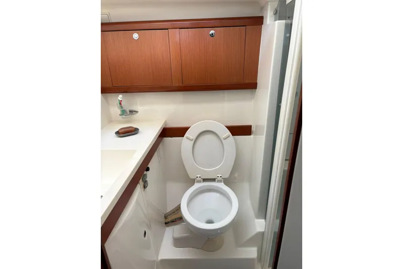  Yacht Photos Pics Bathroom interior of 2008 Beneteau 49 yacht with wooden cabinets and toilet.