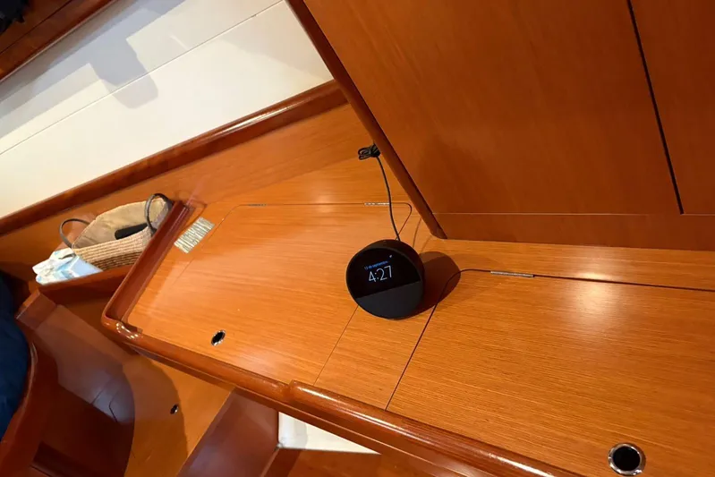  Yacht Photos Pics Wooden interior of a 2008 Beneteau 49 yacht with a digital clock on the counter.