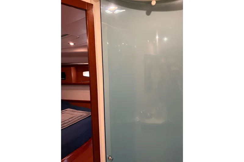  Yacht Photos Pics Interior of 2008 Beneteau 49 yacht showing bedroom and frosted glass door.