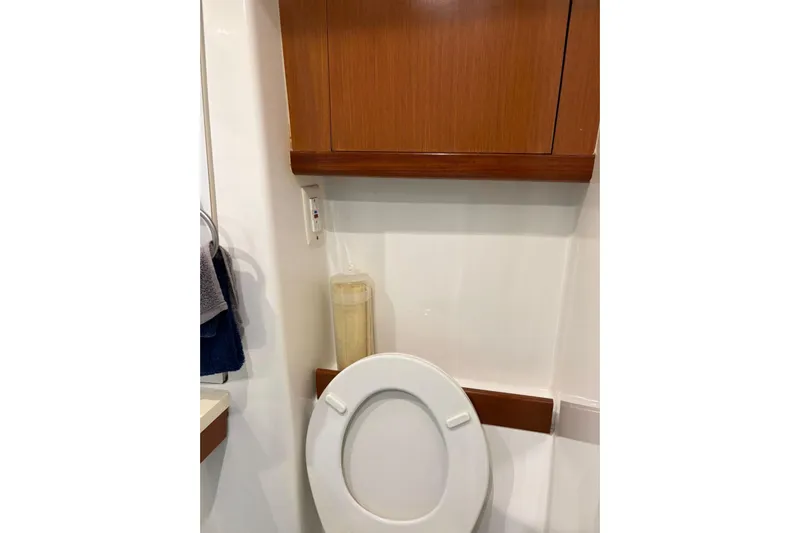  Yacht Photos Pics Bathroom interior of 2008 Beneteau 49 yacht with wooden cabinet and toilet.