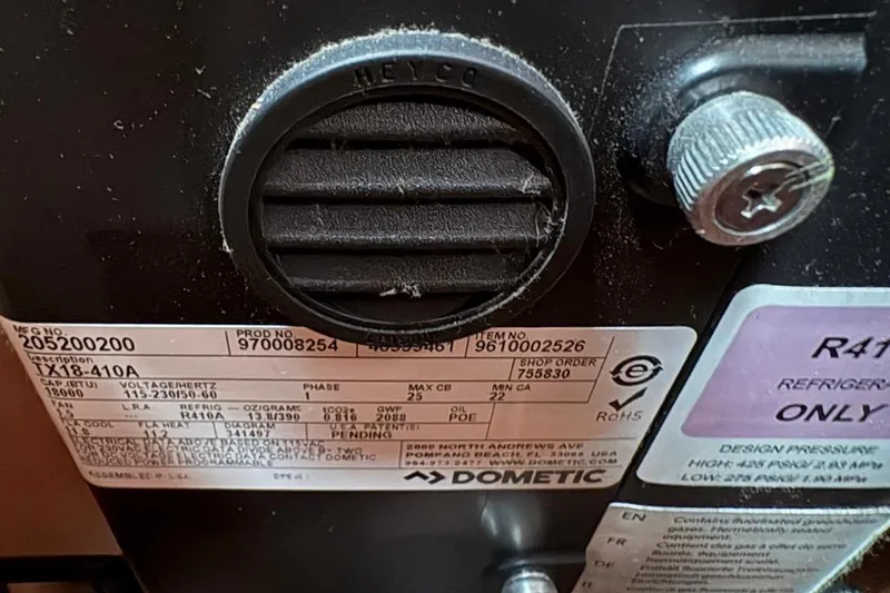  Yacht Photos Pics Close-up of a Dometic appliance label with technical specifications and serial numbers.