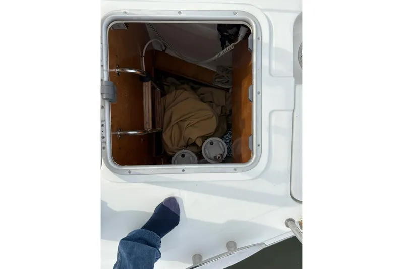  Yacht Photos Pics Open hatch on 2008 Beneteau 49 sailboat, showing interior storage and ladder.