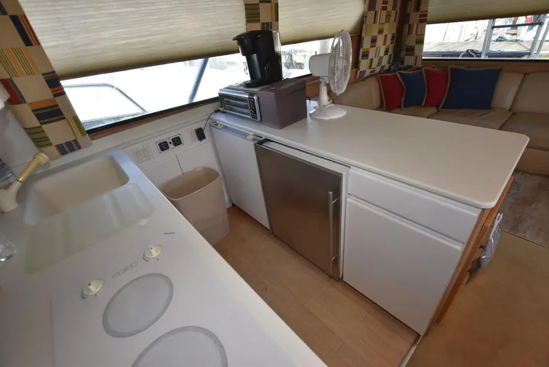 Crazy Train Yacht Photos Pics Interior of 1996 Hatteras 50 Convertible yacht with modern kitchen amenities.