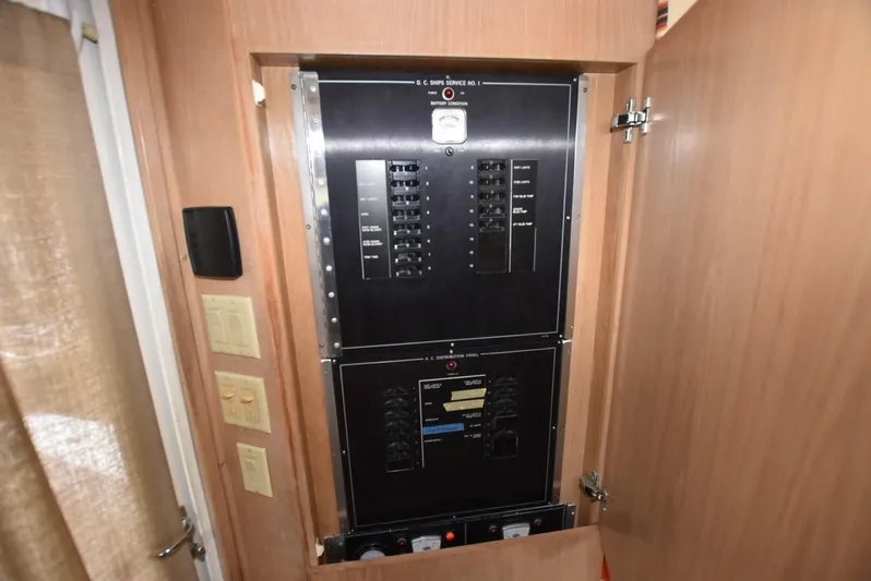 Crazy Train Yacht Photos Pics Electrical panel inside a 1996 Hatteras 50 Convertible yacht, showcasing circuit breakers.