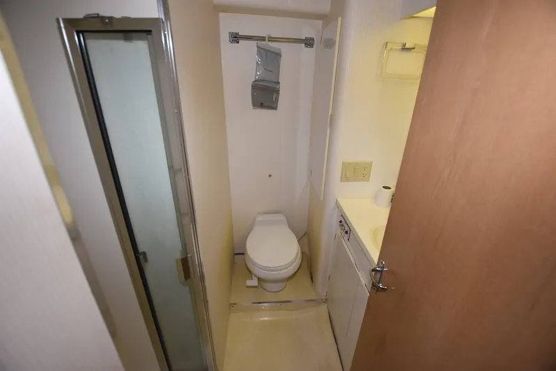 Crazy Train Yacht Photos Pics Bathroom interior of 1996 Hatteras 50 Convertible yacht, featuring shower and toilet.