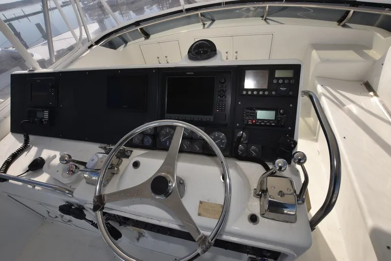 Crazy Train Yacht Photos Pics 1996 Hatteras 50 Convertible yacht helm with steering wheel and navigation controls.