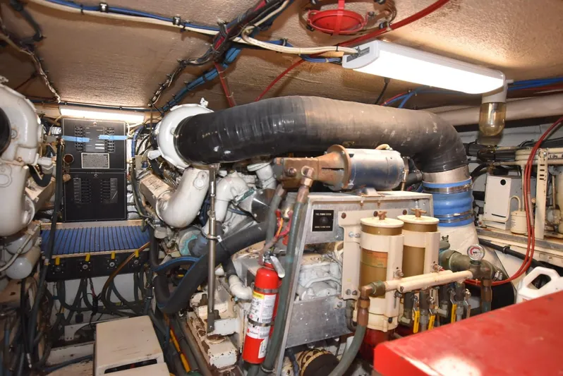 Crazy Train Yacht Photos Pics Engine room of a 1996 Hatteras 50 Convertible yacht, featuring complex machinery and equipment.