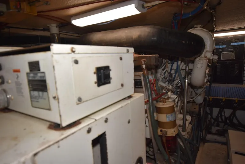 Crazy Train Yacht Photos Pics Engine room of a 1996 Hatteras 50 Convertible yacht, showcasing machinery and equipment.