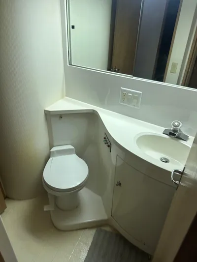 Crazy Train Yacht Photos Pics Bathroom interior of 1996 Hatteras 50 Convertible yacht, featuring toilet and sink.