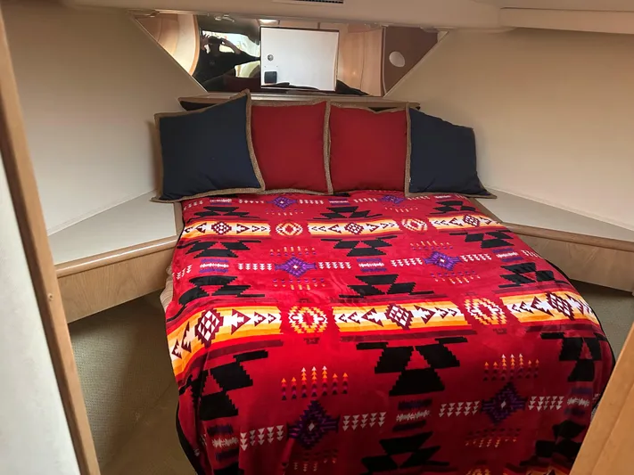 Crazy Train Yacht Photos Pics Cozy bedroom in 1996 Hatteras 50 Convertible yacht with vibrant patterned bedding.
