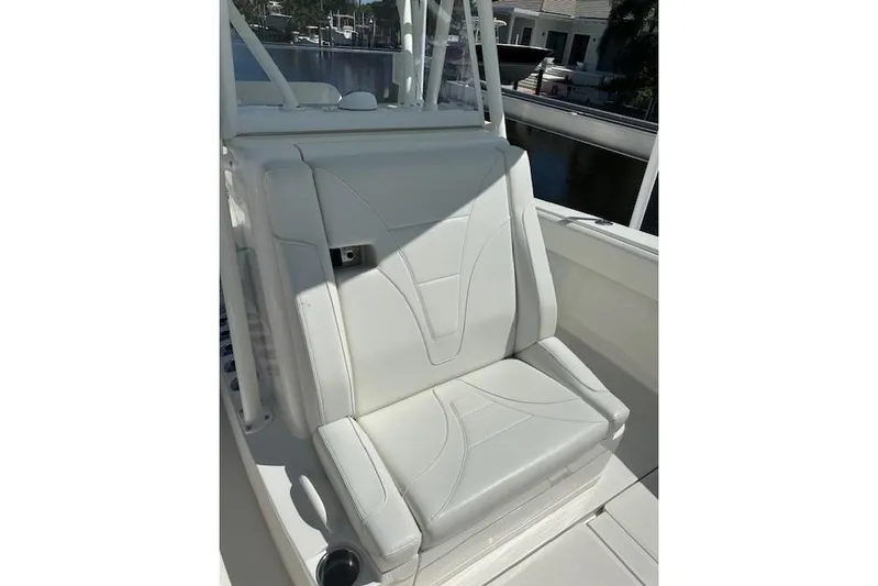 Reel Craft Yacht Photos Pics 2024 SeaVee 340Z boat seat, white upholstery, sleek design, outdoor setting.