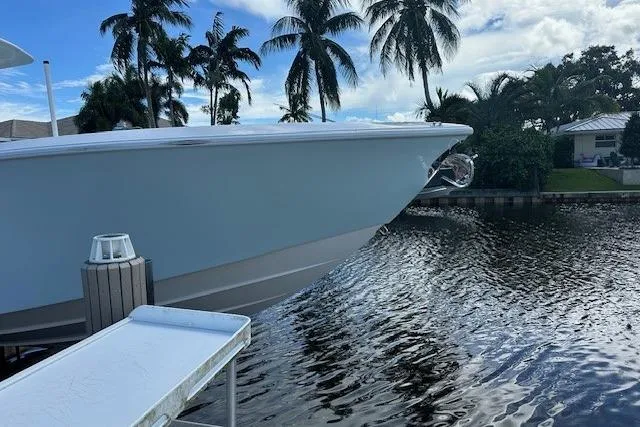 Reel Craft Yacht Photos Pics 2024 SeaVee 340Z boat docked by a scenic waterfront with palm trees.