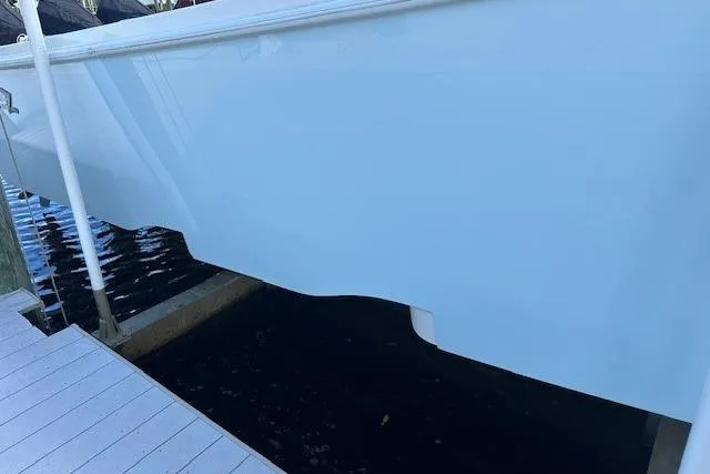 Reel Craft Yacht Photos Pics 2024 SeaVee 340Z boat hull docked, showcasing sleek design and smooth finish.