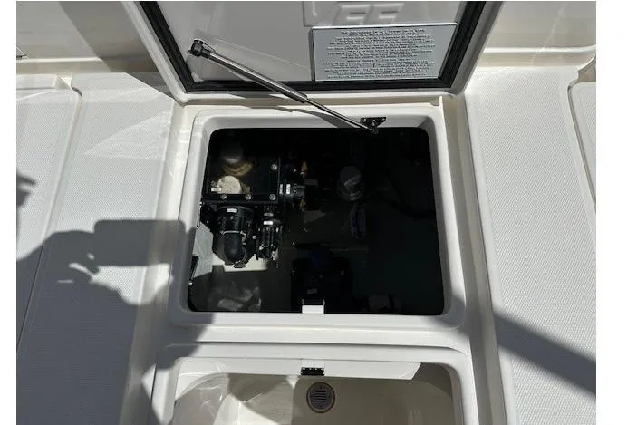 Reel Craft Yacht Photos Pics 2024 SeaVee 340Z boat compartment with open hatch, showcasing internal components.