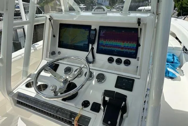 Reel Craft Yacht Photos Pics 2024 SeaVee 340Z boat dashboard with dual navigation screens and steering wheel.