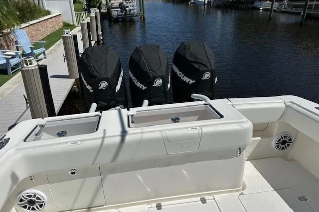 Reel Craft Yacht Photos Pics 2024 SeaVee 340Z boat with triple Mercury engines docked by the water.