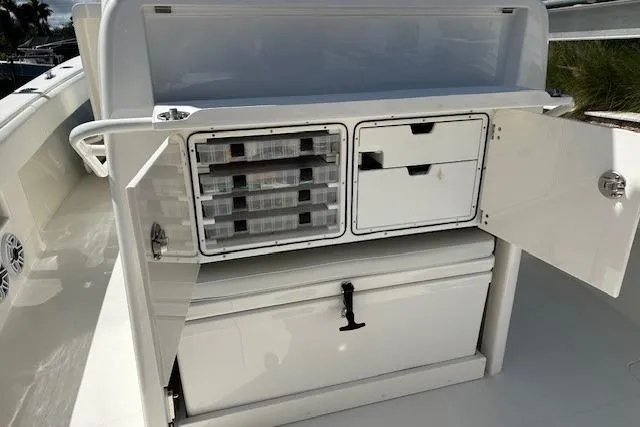 Reel Craft Yacht Photos Pics 2024 SeaVee 340Z boat storage compartments with open doors and organized tackle boxes.