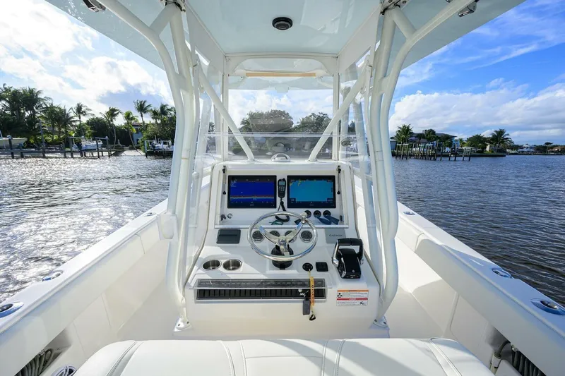 Reel Craft Yacht Photos Pics 2024 SeaVee 340Z boat helm with dual screens, steering wheel, and water view.