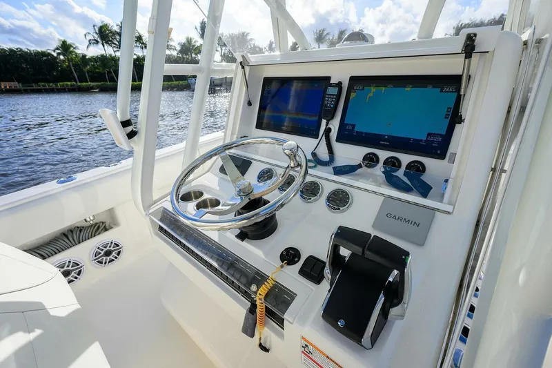 Reel Craft Yacht Photos Pics 2024 SeaVee 340Z boat dashboard with Garmin navigation system and steering wheel.