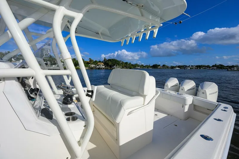 Reel Craft Yacht Photos Pics 2024 SeaVee 340Z boat with white seating and multiple Mercury engines on a sunny day.