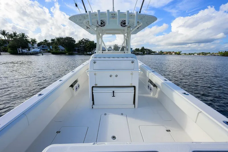 Reel Craft Yacht Photos Pics 2024 SeaVee 340Z boat interior, featuring spacious deck and modern amenities on a serene waterway.