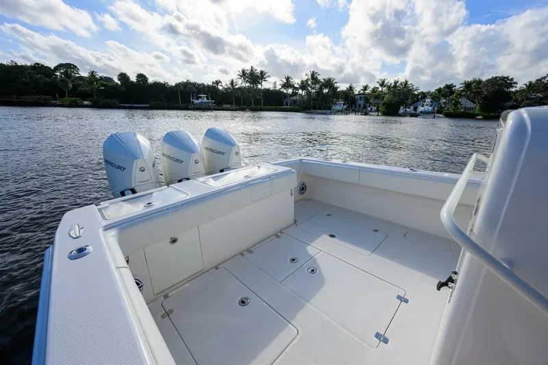 Reel Craft Yacht Photos Pics 2024 SeaVee 340Z boat with triple Mercury engines on a serene waterway.